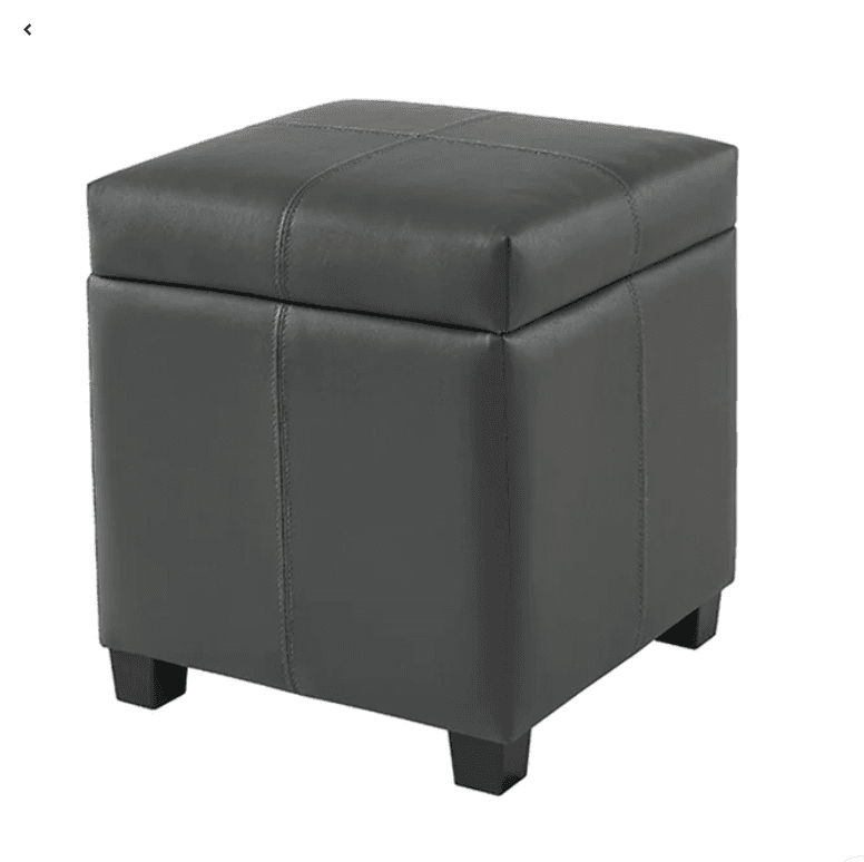 A square, dark gray upholstered ottoman featuring a removable top for storage. The exterior is covered in faux leather with visible stitching details on the top and sides, and it rests on four short, dark-colored block feet. — 3D model