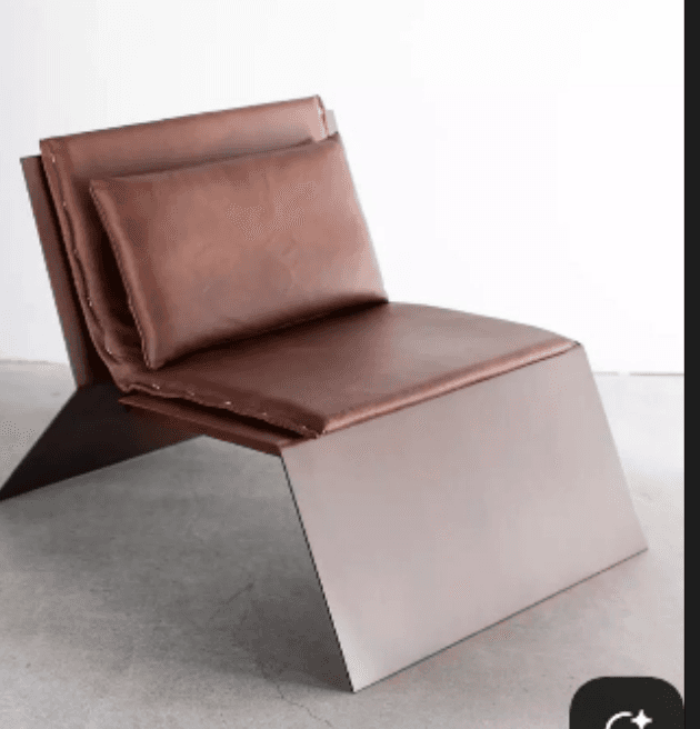 A modern lounge chair with a low profile and angular design. The chair features a dark metal frame with a brushed finish, supporting a seat and back cushion upholstered in brown leather. A separate, smaller leather cushion is placed against the backrest for added comfort. — 3D model