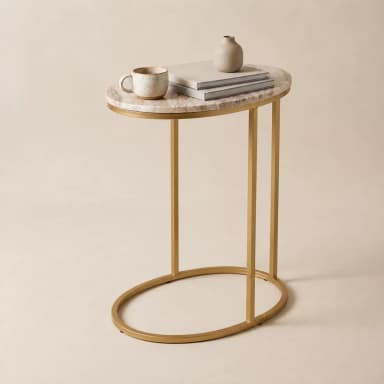 A modern C-shaped side table featuring an oval marble top and a gold-finished metal frame. The table's design allows its base to slide under a sofa or chair, bringing the tabletop closer to the user. — 3D model
