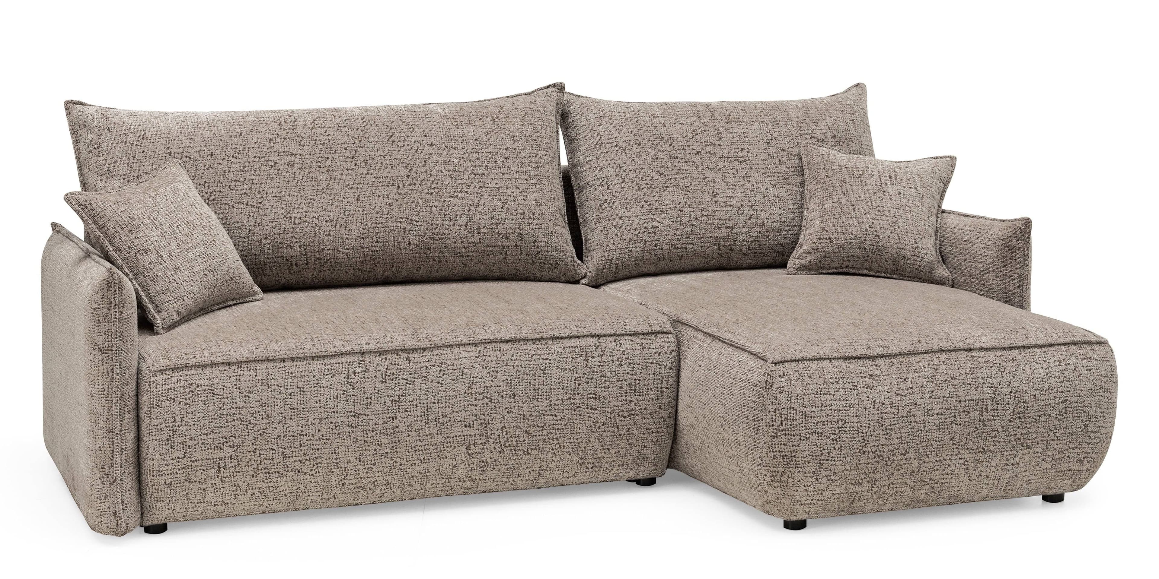A contemporary sectional sofa upholstered in a light brown, multi-tonal textured fabric. It features a two-part construction with a main sofa section and an attached chaise lounge. The design includes plump, loose back cushions and square throw pillows, offering a comfortable and casual aesthetic. The sofa sits on low, discreet black block feet, and all edges are finished with visible piping. — 3D model