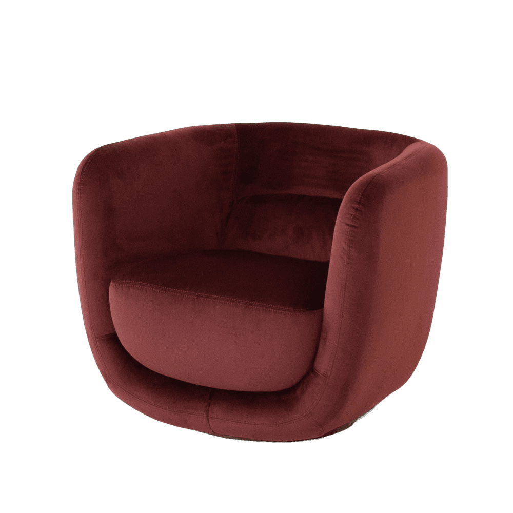 A plush armchair upholstered in a deep red velvet fabric. The armchair features a rounded, semi-enclosed silhouette with integrated armrests that flow seamlessly into the backrest. The seat cushion is thick and plush, while the base of the chair has a subtle curve that provides a sense of depth. The upholstery is smooth with visible stitching details on the seat cushion and along the edges of the chair's structure. — 3D model