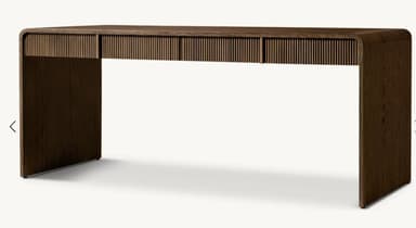 A modern desk constructed from dark wood, featuring a distinctive waterfall edge design where the tabletop seamlessly curves down to form the legs. The desk includes three integrated drawers with fluted fronts, adding a textural element to its minimalist form. — 3D model
