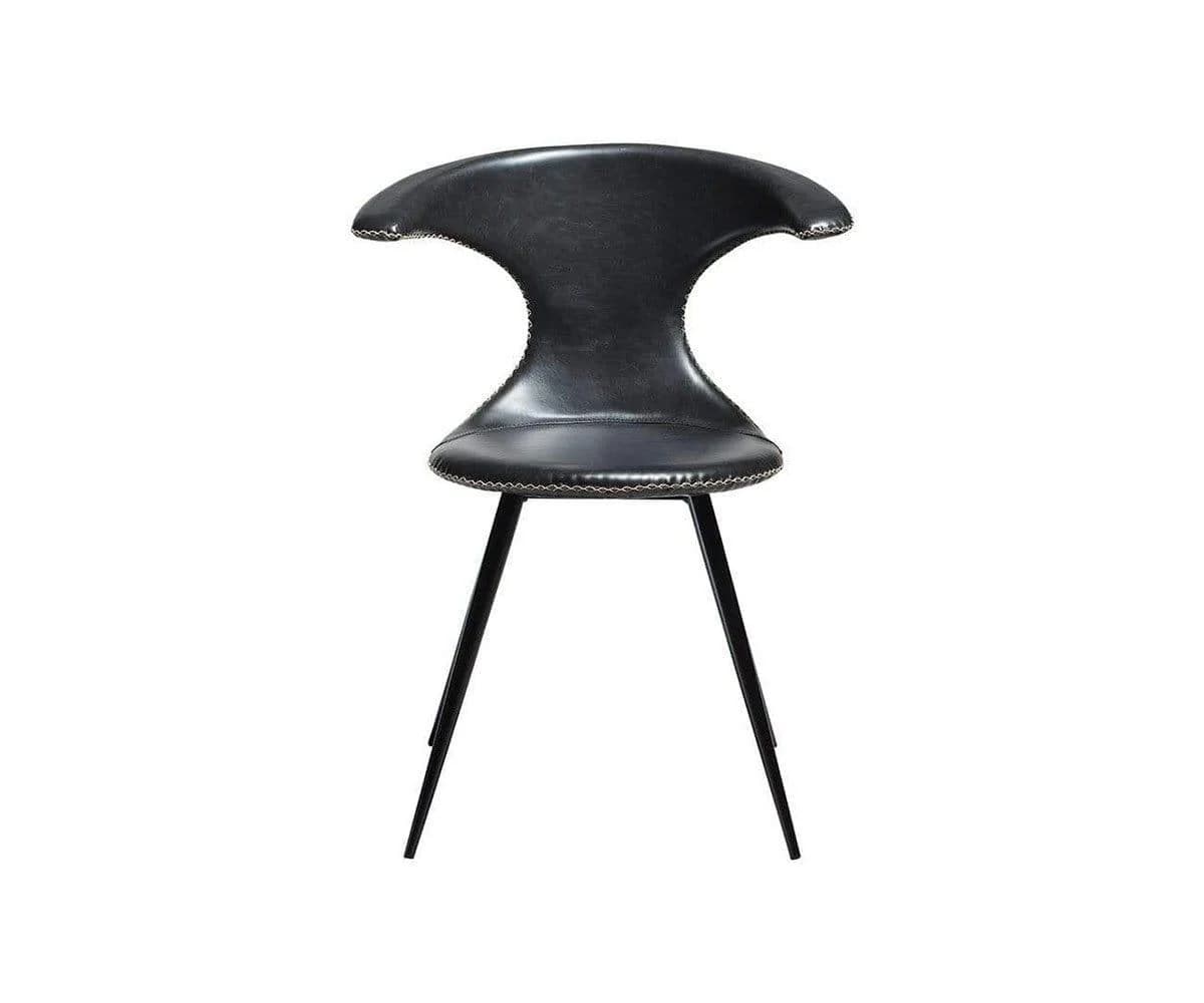 A modern black chair featuring a uniquely sculptural seat and backrest upholstered in what appears to be leather or faux leather with prominent contrasting white stitching. The backrest flares out at the top and narrows significantly at the waist before widening again for the seat. It is supported by four slender, angled black metal legs. — 3D model
