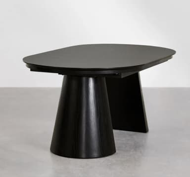 An oval-shaped dining table crafted from dark wood, featuring a tabletop that appears to be extendable, indicated by a central seam. The table is supported by two substantial, tapered pedestal bases that provide a modern and stable foundation. — 3D model
