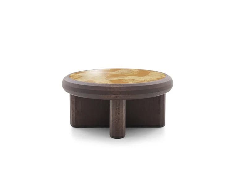 A low-profile round coffee table featuring a dark stained wooden frame and a distinctive light-colored, patterned inlay top. The table's base consists of thick, rounded and rectilinear elements, giving it a robust and grounded appearance. The top surface is circular with a subtly textured or metallic-look pattern, set within a thick, rounded wooden rim that matches the base. — 3D model