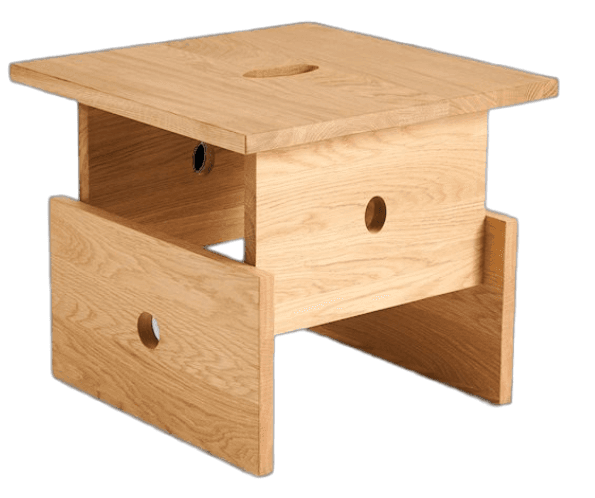 A compact, square, light-colored wooden object with a minimalist design, featuring a flat top with an oval cutout, a central box-like structure, and two vertical plank supports with circular cutouts. — 3D model