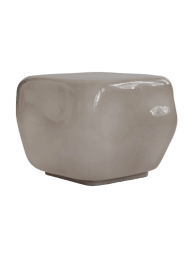 A modern sculptural side table featuring a rounded, cubic form and a glossy, smooth greige surface, resting on a subtle plinth base. — 3D model