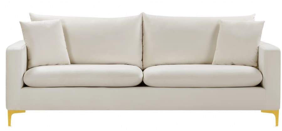 A modern sofa upholstered in a cream or off-white velvet-like fabric, featuring two plush seat cushions and two large back cushions. Two smaller square throw pillows are included. The sofa has clean, squared track arms and is supported by slender, tapered gold-finished metal legs at each corner. — 3D model