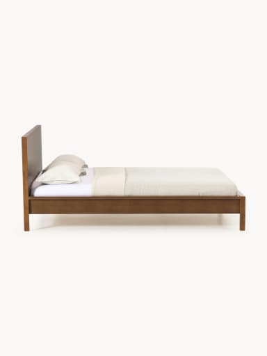 A modern platform bed featuring a clean, minimalist design crafted from dark-stained wood. It includes a solid, rectangular panel headboard and a low-profile frame with integrated legs, designed to support a mattress without the need for a box spring. The bed frame exhibits a smooth, finished surface. — 3D model