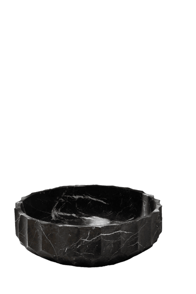 A striking black marble vessel sink with a faceted exterior. The interior is smoothly finished and features natural white veining characteristic of marble. The geometric design of the exterior adds a contemporary, sculptural element to this functional bathroom fixture. It is designed to sit atop a countertop, rather than being recessed. — 3D model