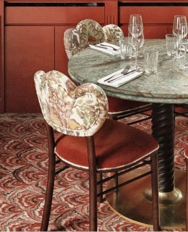 A side chair featuring a dark wood frame, a solid reddish-brown upholstered seat, and a distinctive heart-shaped backrest covered in a multi-colored floral tapestry fabric. The chair stands on four straight legs with cross stretchers for stability. — 3D model