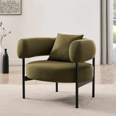 A modern armchair with a rounded, barrel-like silhouette. It features a fully upholstered seat, back, and integrated armrests, creating a continuous form. A single matching throw pillow is placed on the seat. The armchair is supported by four slender, dark-colored legs that extend from beneath the seat. — 3D model