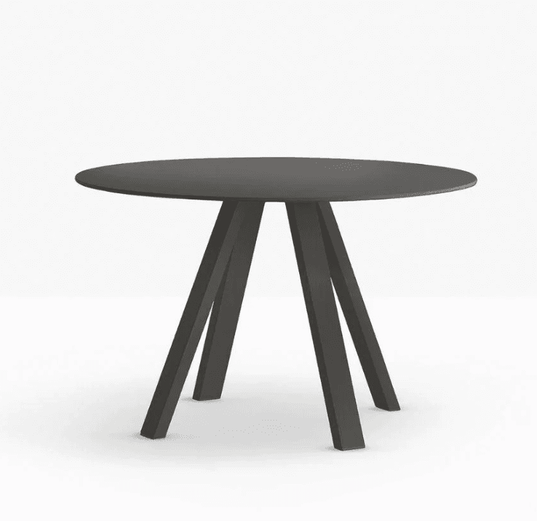 A round dining table with a dark grey matte finish. The tabletop is thin and appears to be solid. The base consists of four angled legs that converge towards the center, creating an open, sculptural design. The legs have a rectangular profile and are set at distinct angles to provide stability. — 3D model