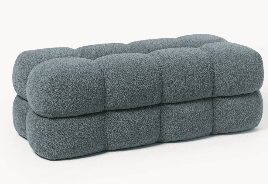 A contemporary, rectangular bench featuring deeply tufted, rounded segments upholstered in a textured, slate-blue fabric. The design emphasizes soft, pillowy forms with a modular aesthetic. — 3D model