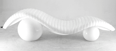 A contemporary white chaise lounge with a distinctive sculptural design. The seating surface is elongated and features horizontal channel tufting, creating a ribbed effect. It is supported by two spherical bases, one positioned towards the front and the other towards the rear, providing an unusual and dynamic stance. The overall form is organic and flowing. — 3D model