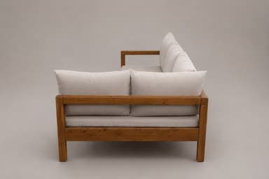 An L-shaped sectional sofa featuring a prominent light-toned wooden frame and light beige fabric cushions. The sofa consists of a longer three-seater section and a shorter extension, forming an 'L' shape. The design is modern and casual, with visible wooden armrests and legs, and soft, loose back cushions. — 3D model