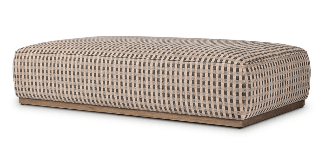 A rectangular upholstered ottoman featuring a black and light beige checkered fabric pattern and resting on a subtle, recessed light wood plinth base. — 3D model