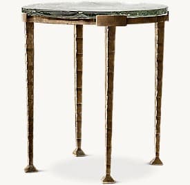 A compact, round accent table featuring a thick, heavily textured fused glass top supported by a four-legged, sculptural bronze-toned metal base with a chiseled texture. — 3D model