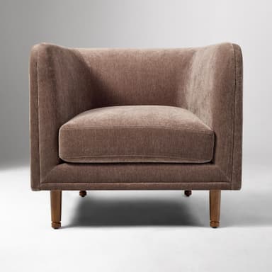 A contemporary upholstered club armchair featuring a single, removable seat cushion, integrated flared arms, and a low back, all covered in a textured, brown fabric. The chair stands on four tapered wooden legs. — 3D model
