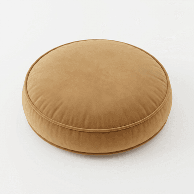 A circular, thick floor cushion upholstered in a soft, golden-brown velvet-like fabric. It features piping around its circumference on both the top and bottom edges, defining its plush, structured shape. The cushion is designed for comfortable, low-level seating or as a footrest. — 3D model
