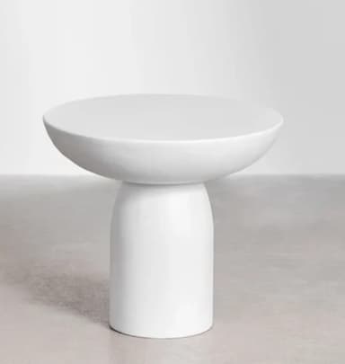 A minimalist white round side table featuring a smooth, matte finish. It consists of a circular tabletop with a slightly dished edge, supported by a sturdy, cylindrical pedestal base that tapers gently towards the top. The design is simple and monolithic, suggesting a modern aesthetic. — 3D model