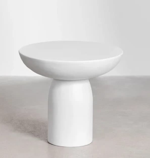 A minimalist white round side table featuring a smooth, matte finish. It consists of a circular tabletop with a slightly dished edge, supported by a sturdy, cylindrical pedestal base that tapers gently towards the top. The design is simple and monolithic, suggesting a modern aesthetic. — 3D model