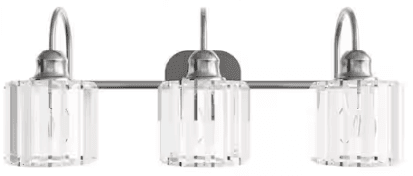 A contemporary three-light wall-mounted vanity light featuring a brushed nickel finish. The fixture includes a rectangular backplate and a horizontal bar from which three individual light units extend. Each light unit consists of a curved arm supporting a cylindrical shade made of clear, vertically fluted glass, exposing the internal bulb. The design balances industrial and modern aesthetics with a touch of elegance from the textured glass. — 3D model