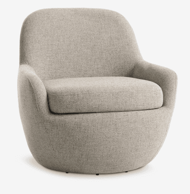 The image displays the back view of a contemporary upholstered barrel armchair. It features a continuous, rounded silhouette with a distinct vertical seam running down the center of the backrest. The chair is covered in a light beige or greige textured woven fabric. The design appears compact and minimalist, with a smoothly curved form that suggests an enveloping, comfortable seat. Small glides or feet are barely visible at the very bottom edge. — 3D model