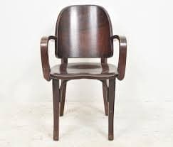 A wooden armchair with a curved backrest and armrests. The chair has a simple, yet elegant design, featuring bentwood elements. The seat is flat and appears to be made of the same wood as the frame. The legs are straight and provide a stable base. — 3D model