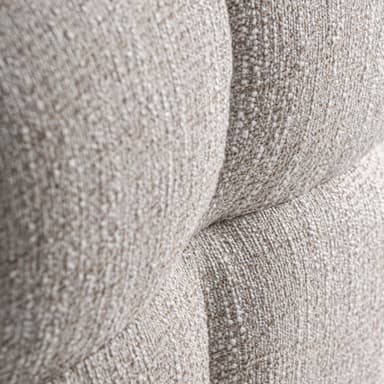 A low, upholstered ottoman with rounded edges, divided into four cushioned sections by stitched seams. The upholstery has a textured appearance with a mix of light and dark fibers, giving it a speckled effect. A small white tag with 'VICAI' is visible on the lower left side. — 3D model
