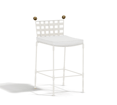 A white bar stool featuring a backrest constructed from wide interwoven straps, a cushioned seat, and decorative brass finials on the back posts. The frame is slender and includes an integrated footrest. — 3D model