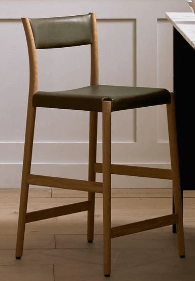 A contemporary bar stool with a wooden frame and a black upholstered seat and backrest. The stool features a curved backrest that extends from the frame. The legs are made of light-colored wood and are connected by horizontal support rails, providing stability. The seat and backrest appear to be upholstered in a dark, possibly leather, material. — 3D model