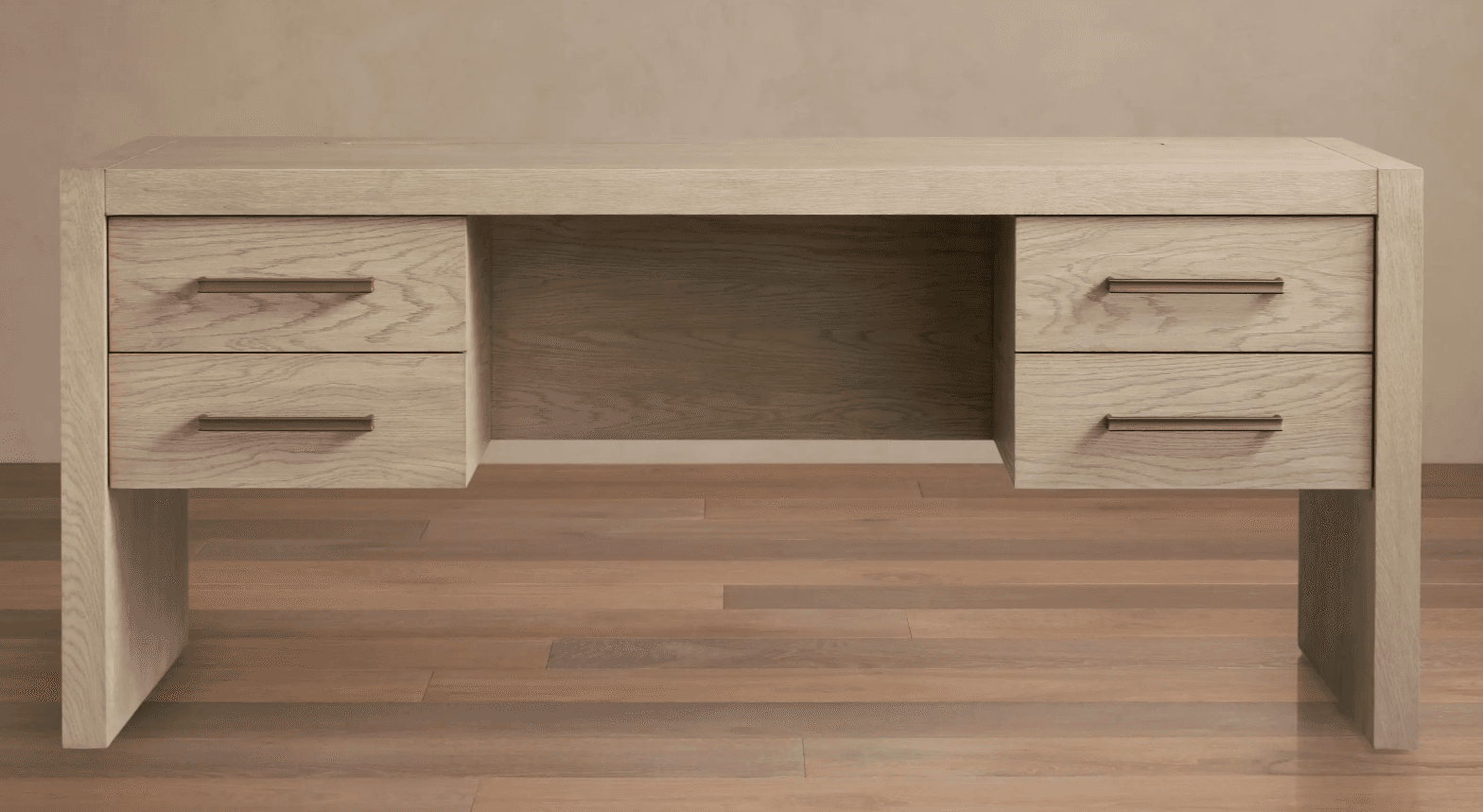 A modern, minimalist desk constructed from light-colored wood with a visible grain pattern. The desk features a rectangular tabletop and two side pedestals, each containing two drawers. The drawers are fitted with slender, horizontal brass-toned handles. The overall design is clean and functional, with an open central compartment between the pedestals. — 3D model