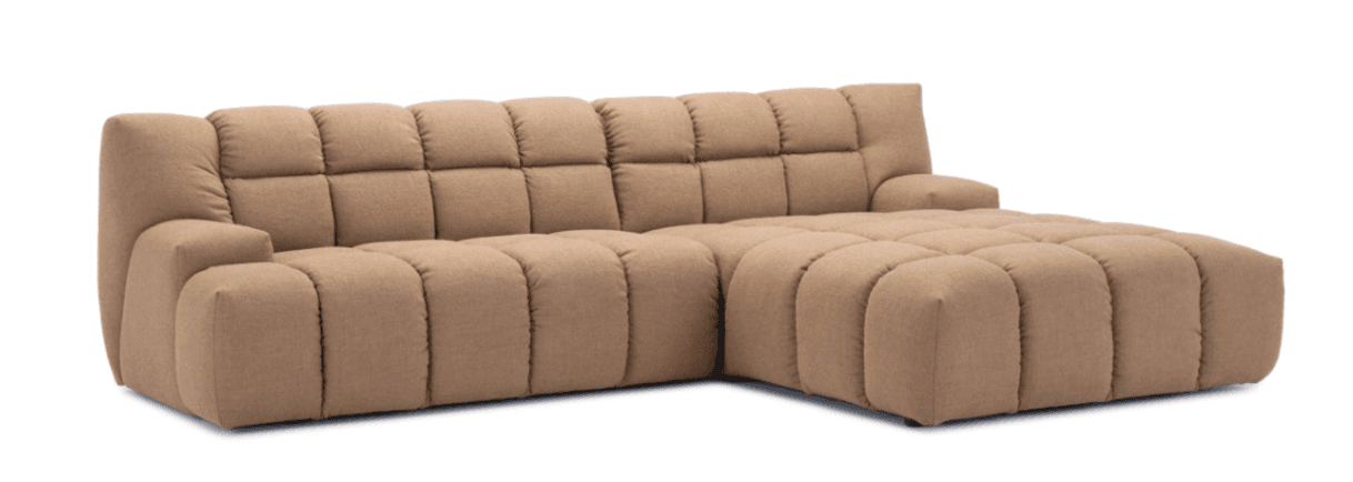 This is a modular sectional sofa featuring a chaise lounge configuration. The sofa is upholstered in a textured, light brown fabric and exhibits a distinct design characterized by deep, quilted channels across its backrests and seating surfaces, creating a plush, segmented appearance. It includes a left-arm sofa component and a right-arm chaise, offering ample seating and lounging space. The low-profile design with integrated armrests and a rounded, substantial form contributes to a contemporary and comfortable aesthetic. — 3D model