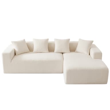 A modern, cream-colored sectional sofa featuring a chaise lounge component and an integrated storage pocket on one armrest. The sofa is upholstered in a textured fabric, likely boucle, providing a soft and inviting appearance. It has a low-profile, modular design with clean lines and includes several loose back cushions of the same material. — 3D model