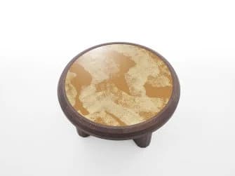 A low-profile round coffee table featuring a dark stained wooden frame and a distinctive light-colored, patterned inlay top. The table's base consists of thick, rounded and rectilinear elements, giving it a robust and grounded appearance. The top surface is circular with a subtly textured or metallic-look pattern, set within a thick, rounded wooden rim that matches the base. — 3D model