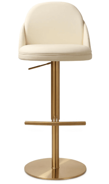 A modern bar stool featuring a cream-colored upholstered seat and backrest, mounted on a brushed brass-finished metallic base. The seat has a rounded, gently curved backrest, offering partial arm support. The central column is height-adjustable via a lever located beneath the seat. A circular footrest extends from the column, and the stool rests on a flat, circular base. — 3D model