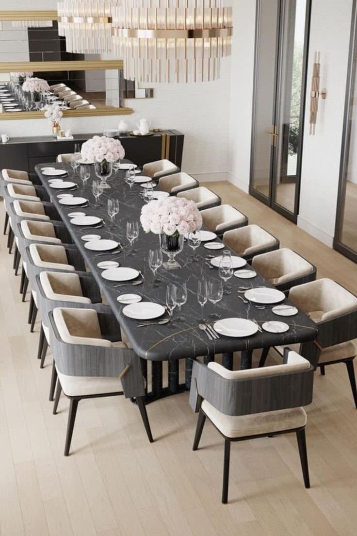 A rectangular coffee table with rounded corners. The tabletop has a dark, marble-like finish with fine, irregular gold veining. It is supported by two rectangular, solid legs positioned towards the center of the longer sides, creating a minimalist and modern aesthetic. The overall impression is one of sleekness and contemporary design. — 3D model