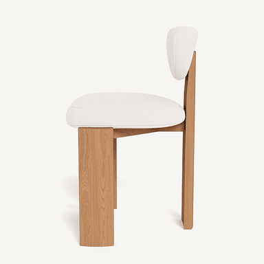 A modern chair with a distinct design featuring a wooden frame and a cushioned seat and backrest. The frame has a blocky, geometric construction with thick, upright legs and a similarly structured seat support. The backrest is curved and upholstered. The visible wood grain suggests a natural finish. — 3D model