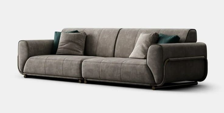 A contemporary three-seater sofa upholstered in a greyish-brown fabric, featuring rounded armrests, integrated back cushions, and a minimalist dark metal frame that extends to form the feet. Two additional throw pillows, one grey and one dark teal, are present. — 3D model