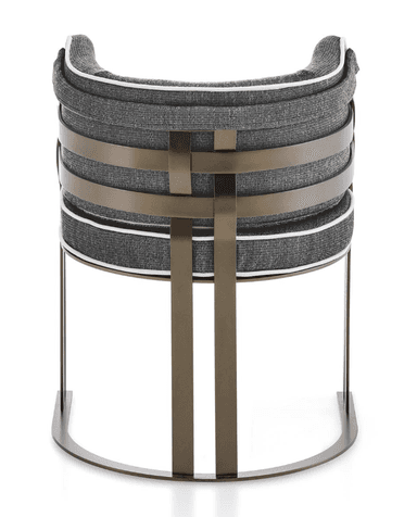 A modern armchair with a curved backrest and seat, upholstered in a textured dark grey fabric with white piping. The armchair features a metal frame with a brushed bronze finish, consisting of a U-shaped base and vertical legs supporting the seat. The backrest is accented with horizontal metal straps. — 3D model