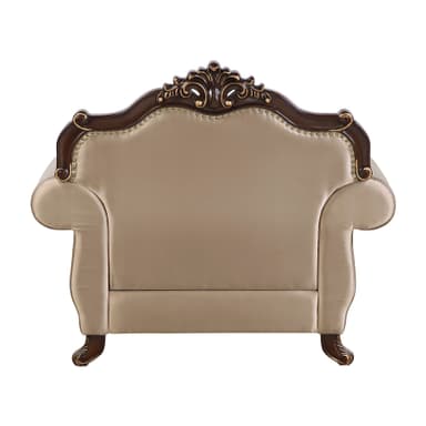 An ornate single-seater armchair featuring a dark, richly carved wooden frame with gilded accents, and plush, light beige upholstered seating. The chair's design includes a prominent crest rail with intricate rococo-style carvings, scrolled armrests, and cabriole-style legs, all detailed with gold. The upholstery is secured by continuous brass nailhead trim along the edges. — 3D model
