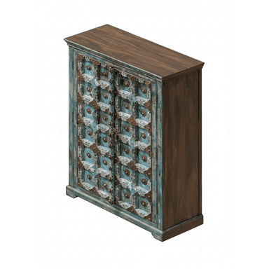 A distressed, carved wooden cabinet with two doors featuring intricate patterns. The doors are adorned with metal decorative elements and have a distressed blue and white finish. The sides of the cabinet appear to be a dark wood. — 3D model