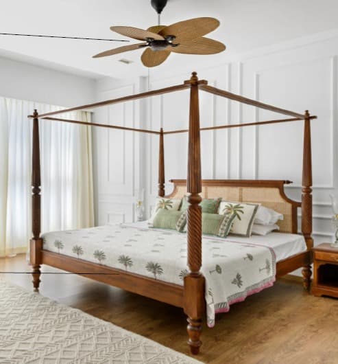 A classic four-poster bed with a wooden frame. The headboard features a cane weave panel. The bed is dressed with a white mattress, a white duvet cover with a green palm tree pattern, and several decorative pillows in coordinating green tones. The bedposts are turned and fluted, and the legs are bulbous. — 3D model
