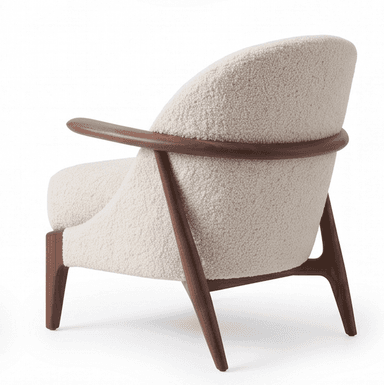 A contemporary armchair featuring an exposed dark wood frame with a curved backrest and integrated armrests. The seat and back are generously upholstered in a cream or off-white boucle fabric, providing a textured and plush appearance. The legs are tapered and splayed, contributing to an elegant and lightweight silhouette. — 3D model