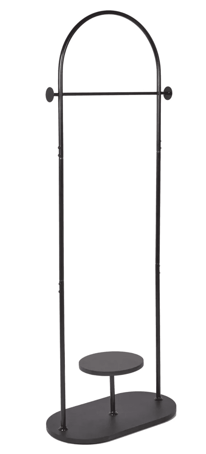 This is a minimalist, freestanding clothes rack constructed from dark metal. It features an arched top supported by two slender vertical posts. A horizontal rod is positioned beneath the arch for hanging garments. The base is an elongated oval, providing stability. An additional, smaller circular shelf is elevated from the base, offering a spot for accessories or small items. The entire piece is finished in a matte black. — 3D model