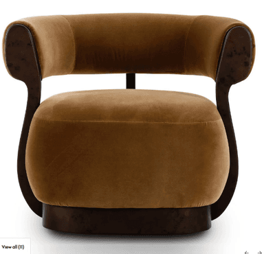 An Art Deco style barrel armchair upholstered in plush brown velvet with a dark, possibly burl wood, veneer frame. The chair features a curved back and integrated arms, all padded and upholstered. The wooden frame provides structural support, flowing from the base up to encompass the back and arms. The seat cushion is thick and round, resting on a sturdy, rounded wooden base. — 3D model