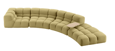 A modular, sectional sofa with a curved configuration. Each module consists of multiple tufted cushions, creating a soft, pillowed appearance. The sofa is upholstered in a textured fabric and features a light-colored, organically shaped tray attachment on one of the sections. — 3D model