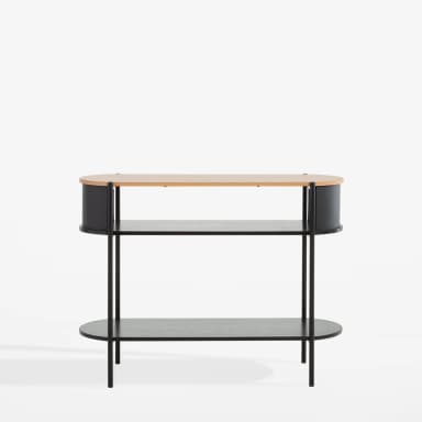 A close-up view of a modern two-tier side table, featuring a light-colored wood tabletop with rounded edges. Below the top, a curved black panel suggests integrated storage or a design enclosure. The table is supported by black vertical cylindrical legs, which also connect to a lower, dark wood-grain shelf, emphasizing a minimalist and contemporary aesthetic. — 3D model