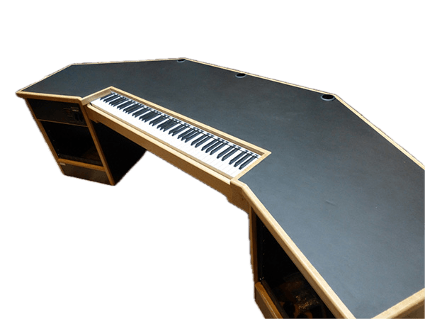 A purpose-built music studio production desk featuring a multi-faceted dark gray work surface with light wood trim. It includes an integrated keyboard tray and rack-mount bays for audio equipment. The desk has an angled design to optimize workflow and provides space for studio monitors and other gear. — 3D model